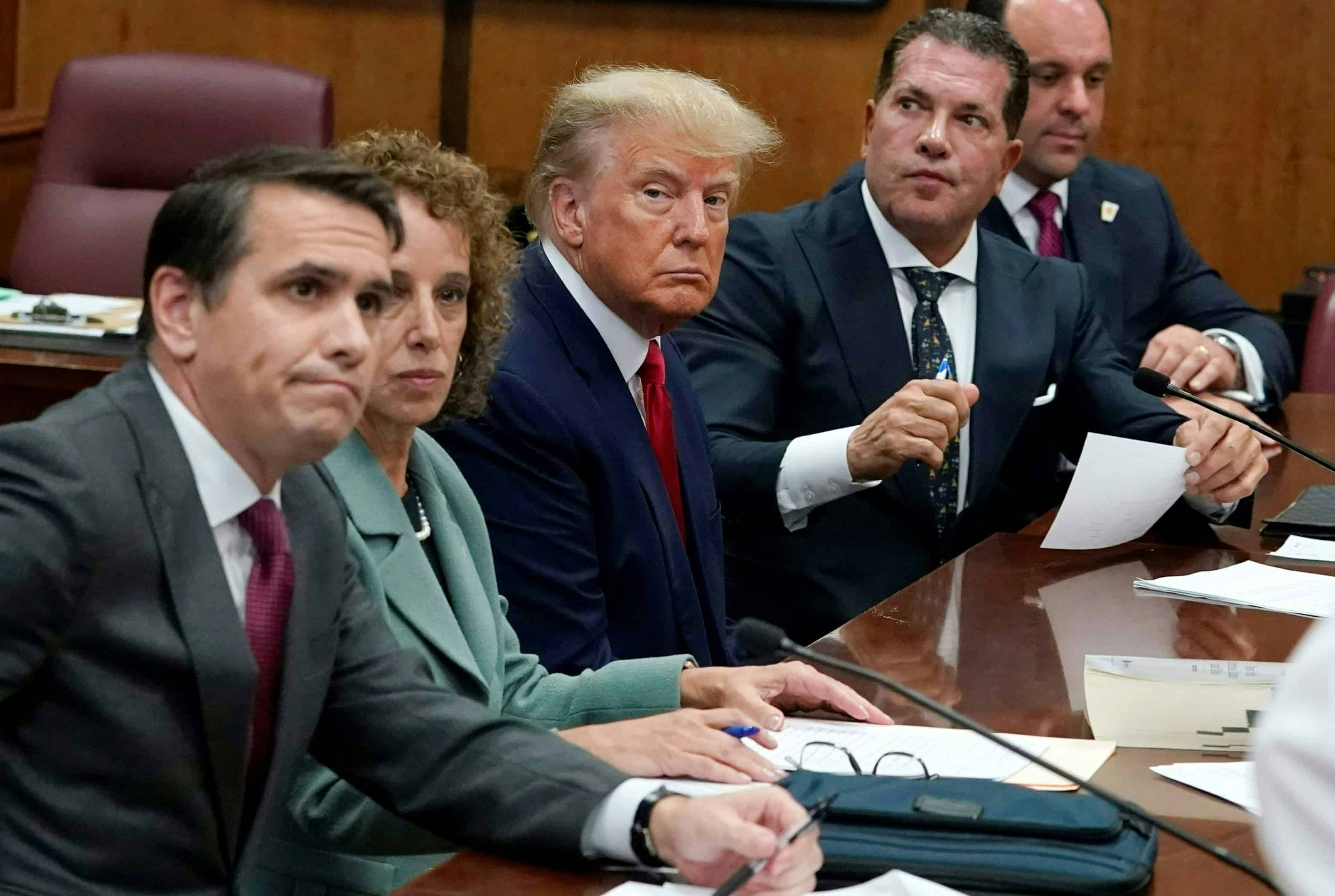 Former US President Donald Trump sits at the defense table with his defense team in a Manhattan court on April 4, 2023 in New York City. - Former US president Donald Trump arrived for a historic court appearance in New York on Tuesday, facing criminal charges that threaten to upend the 2024 White House race. (AFP)