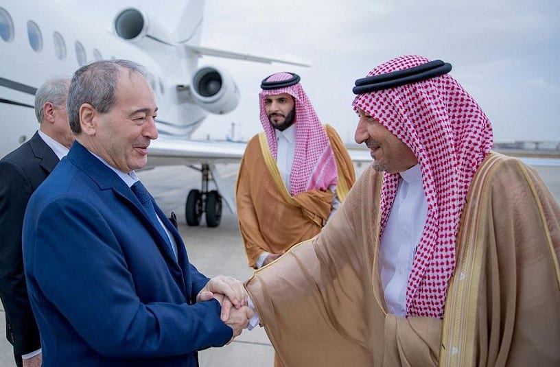 Saudi Deputy Foreign Minister Walid Al Khuraiji, right, receives Syrian Foreign Minister Faisal Mekdad upon his arrival at the airport of Jeddah, Saudi Arabia. (SPA)