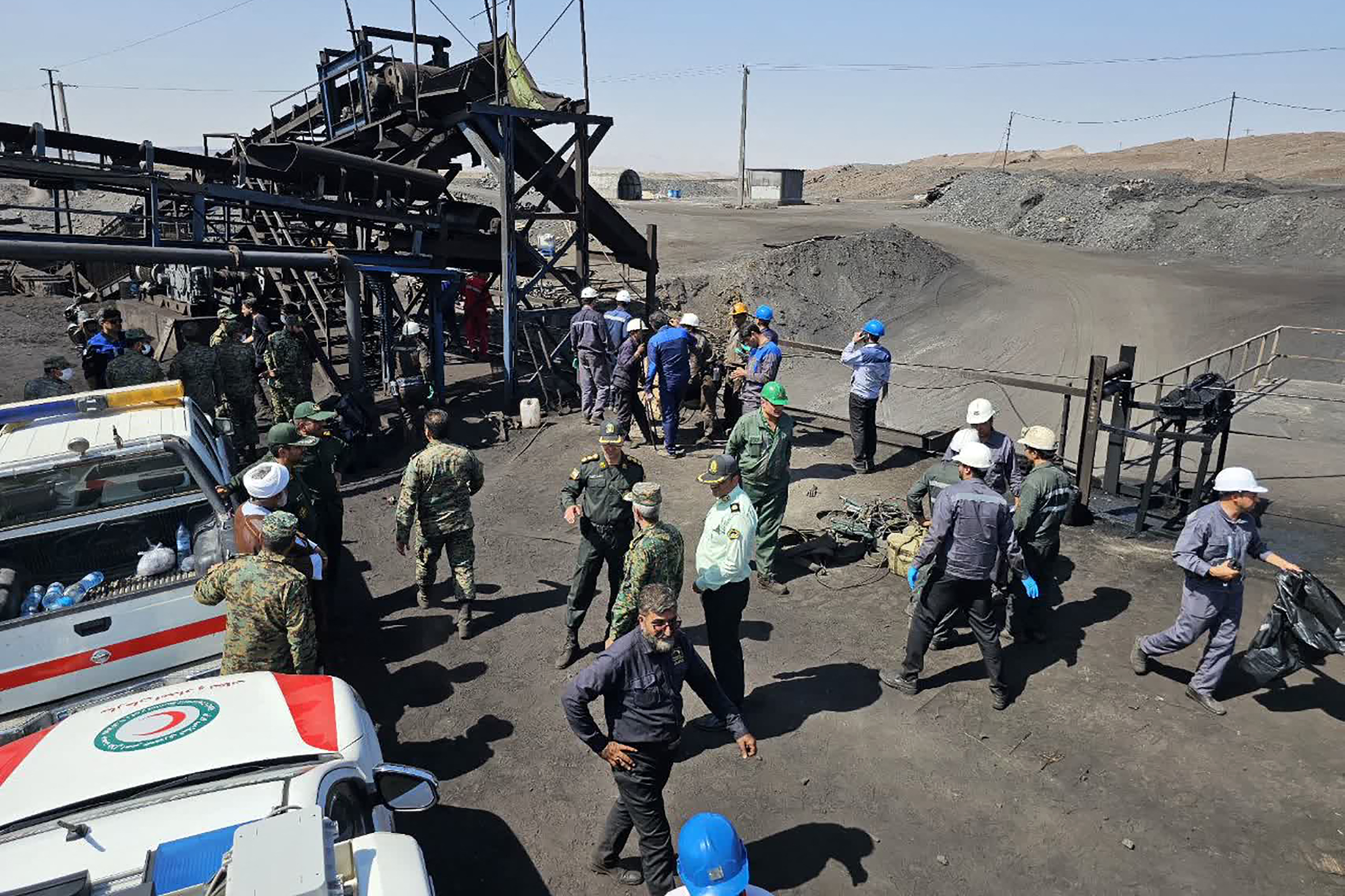 A handout picture provided by the Iranian Red Crescent (RCS) shows security forces gathered at the scene of a blast at a coal mine in Tabas in Iran's Khorasan province on September 22, 2024. (Photo by Iranian Red Crescent / AFP)