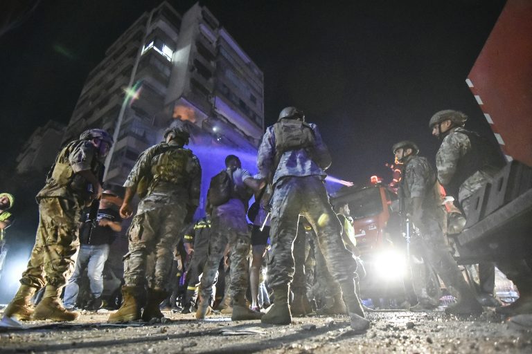 Lebanese army soldiers secure the site outside an apartment building hit by an Israeli air strike in Beirut's Kola district, September 30, 2024. (AFP)