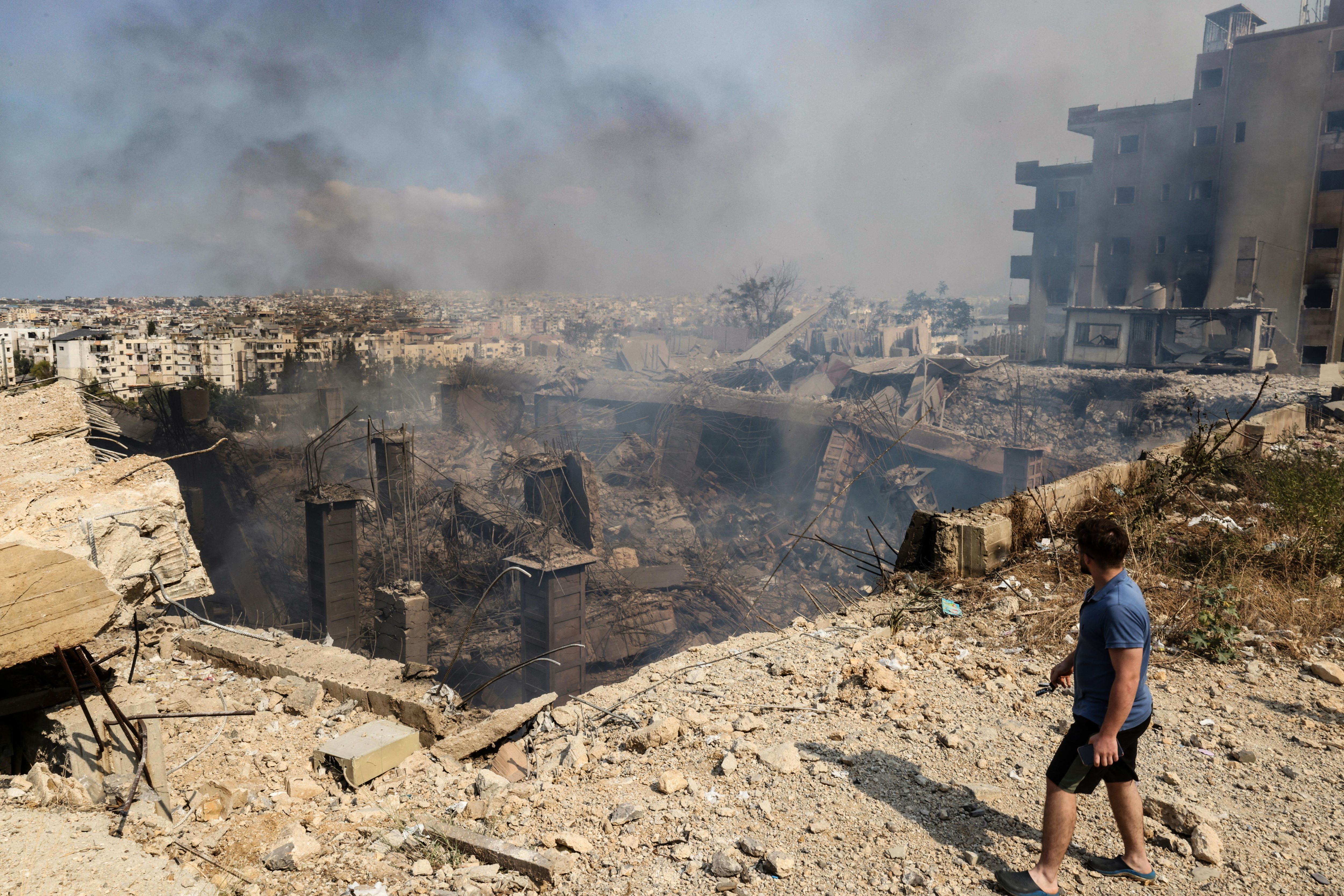 A man checks the destruction at a factory targeted in an overnight Israeli airstrike in the town of Chouaifet south of Beirut on September 28, 2024. (AFP)