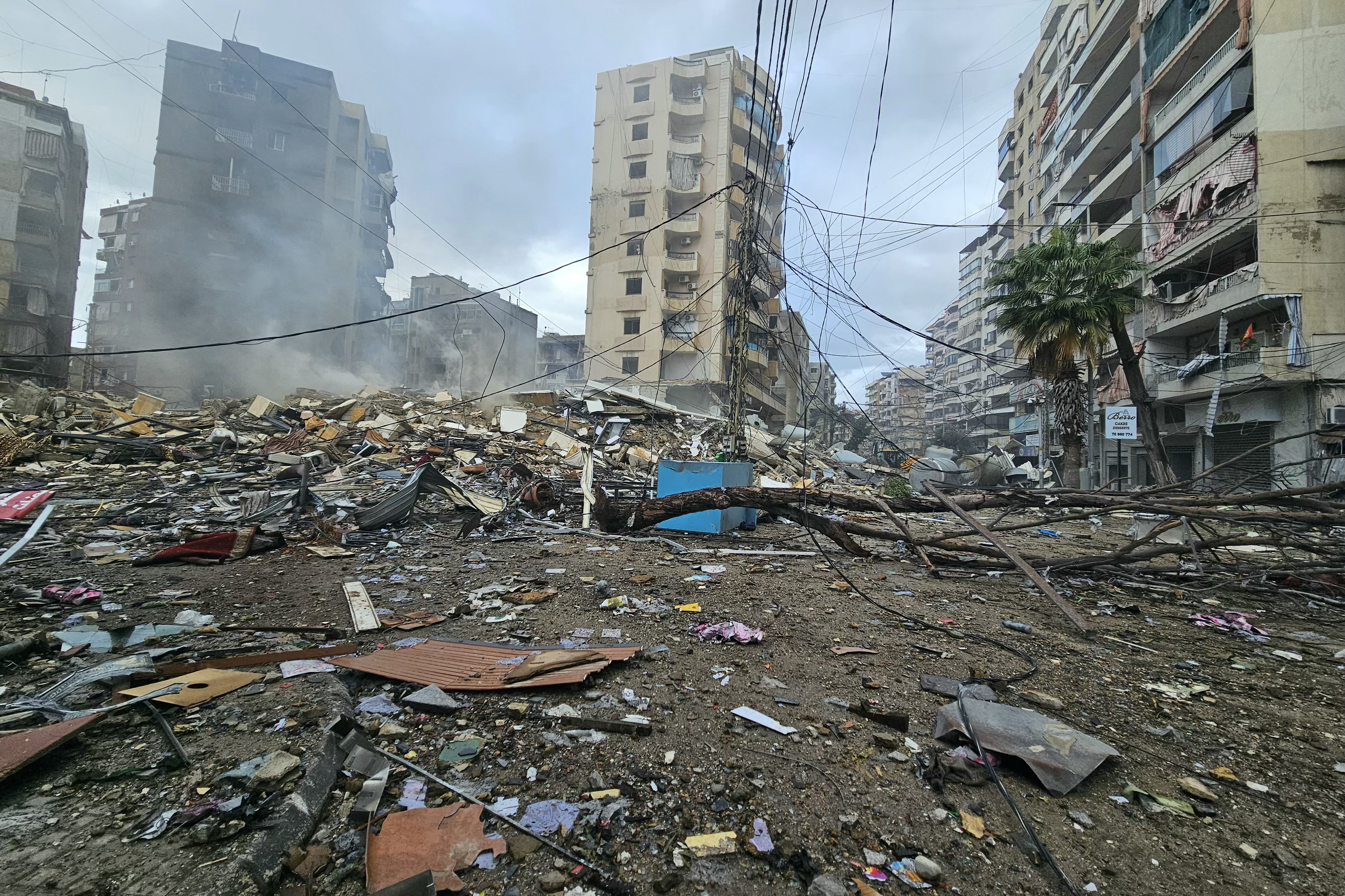 Debris are scattered among damaged buildings in the neighborhood of Rweiss in Beirut's southern suburbs, a day after it was hit by Israeli airstrikes, on November 24, 2024, as the war between Israel and Hezbollah continues. (AFP)